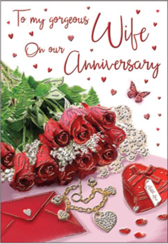 A richly romantic still life unfolds on this anniversary card, designed with the care of a florist who understands the quiet love stories shared across Maidenhead, from quiet cul-de-sacs to riverside walks. A compact bouquet of red roses forms the visual anchor, every blossom fully open and luxuriously layered, their petals plush and velvety in tones that range from deep scarlet at the centre to softer crimson around the edges. The blooms are framed by fresh greenery, slender leaves arcing gently outward, giving a sense of natural abundance without overwhelming the roses' prominence. To one side rests an envelope in a warm neutral shade, its clean lines and slightly raised surface catching a soft wash of daylight, hinting at a handwritten anniversary message inside. Close by, a small, heart-shaped gift box in rich ruby red pairs beautifully with a delicate piece of jewellery - perhaps a necklace or bracelet - whose metallic shine adds a subtle touch of celebration. Tiny heart motifs and gem-like accents are sprinkled across the surface, glimmering subtly like scattered starlight. A graceful butterfly illustration appears to hover above the arrangement, wings outstretched, suggesting lightness and the ongoing journey of a shared life. The card's script winds gently around the imagery, refined yet understated, allowing the flowers and keepsakes to speak most clearly. The overall mood is tender, nostalgic, and quietly joyful, the sort of anniversary sentiment one might choose for a long-married couple in Maidenhead, capturing both the elegance of a florist's work and the depth of emotion behind each passing year.