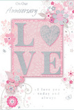 In this image, a tender anniversary card lies open to reveal a design that feels like a soft, whispered promise shared on a quiet evening in Maidenhead. The central feature of the front is the word LOVE, spelled out in raised, softly glittered letters that lend both texture and a subtle sparkle, almost like starlight reflecting on calm river water. The O in LOVE is gently suggested as a rounded, heartlike curve, framed by delicate floral elements. Surrounding the word, clusters of stylised blossoms in blush pinks and muted mauves unfold with a painterly, almost watercolour softness. Fine lines sketch out leaves and slender stems, curving across the card like the flowing stems in a hand-crafted bouquet ready for same-day delivery across town. Tiny details-faint petals, gentle swirls, and discreet butterflies-add a sense of motion, as though a light breeze from nearby Grenfell Park had just brushed through. The colour palette stays within soft pastel pinks and silvery greys, creating a sense of warmth, nostalgia, and romance. Above and below the floral arrangement, the text On Our Anniversary and I love you today and always appears in elegant, understated script, as if lovingly handwritten. The lettering harmonises with the design, never overpowering the imagery but reinforcing the heartfelt message. Overall, the card feels intimate and refined, like a carefully chosen companion to a bouquet of fresh anniversary flowers, capturing the beauty of a shared journey and the quiet joy of celebrating love that has grown deeper over time.